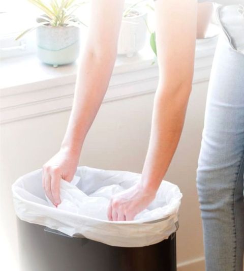 Barrier-bag-white-flat-larger-being-put-in-bin Barrier-bag-white-flat-larger-being-put-in-bin